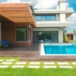 Contemporary villa featuring a swimming pool and elegant patio design, ideal for luxury living.